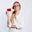 © Elena Kharichkina - Close-up portrait of young smiling business woman holding credit card isolated on white background