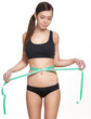 © A.Kazak - Woman measuring her waistline with a green measuring tape, isolated in white. Perfect Slim Body. Diet