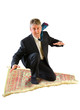 © Michael O'Keene - Business man with a big smile on his face is flying through the air on a magic carpet ride