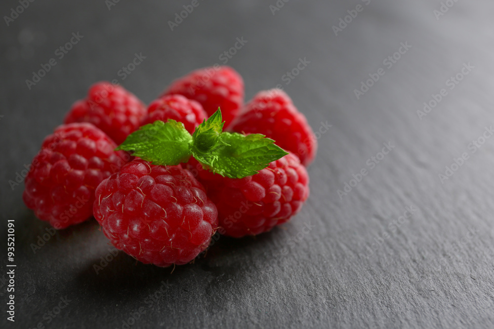 Fresh red raspberries on wooden background