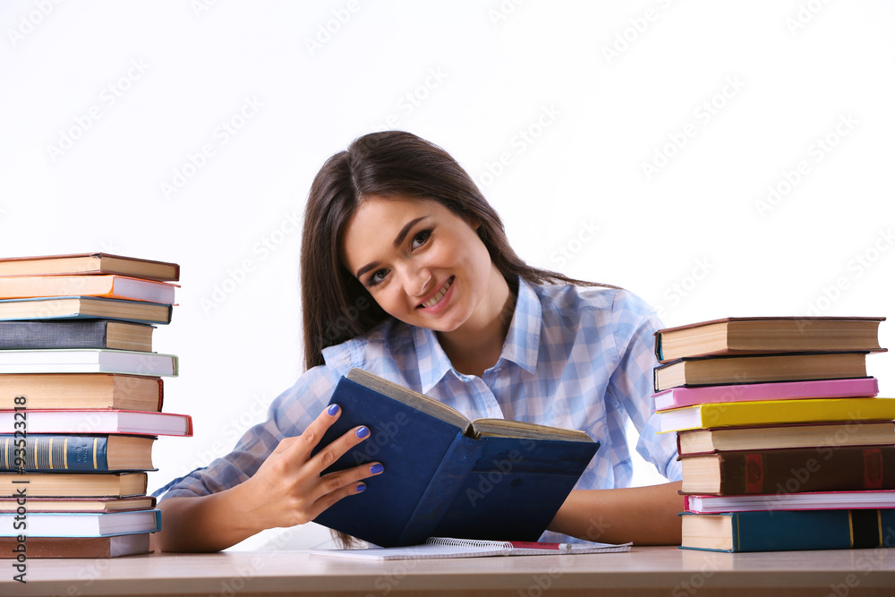Young girl with books isolated on white