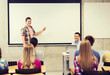 © Syda Productions - group of students and smiling teacher in classroom