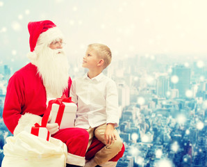 Canvas Print - smiling little boy with santa claus and gifts