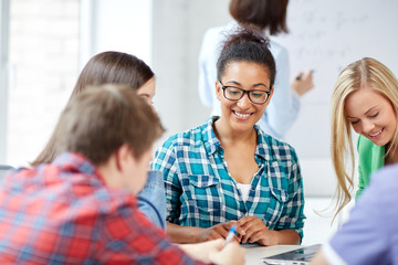 Canvas Print - group of happy high school students with workbook