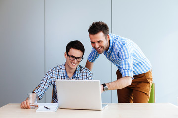 Wall Mural - Two web designers looking at a website they designed