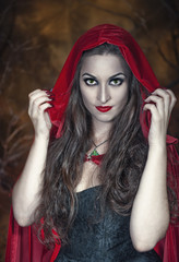 Wall Mural - Beautiful halloween woman in red cloak