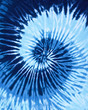 close up shot of spiral blue tone color tie dye fabric texture background