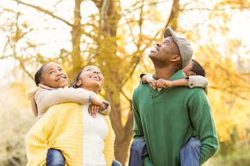 Wall Mural - Portrait of a young smiling family in piggyback