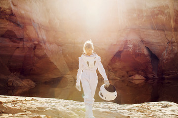 Wall Mural - futuristic astronaut without a helmet in rays of another sun