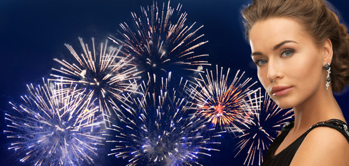 Wall Mural - beautiful woman wearing earrings over firework