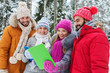 © Syda Productions - smiling friends with tablet pc in winter forest