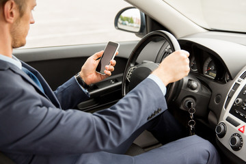 Wall Mural - close up of man with smartphone driving car