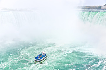 boat tour at niagara falls with spraying water