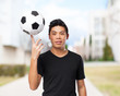 © asierromero - happy chinese-sport-man with soccer-ball