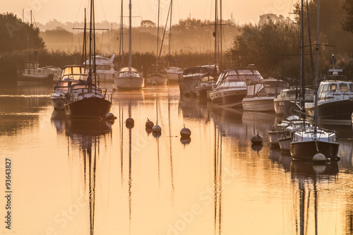 Tapeta ścienna na wymiar boats moored in river at sunrise