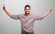 © asierromero - portrait of a young man pointing up with both hands