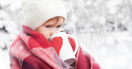 Poster - happy child girl with cup of hot drink on cold winter outdoors