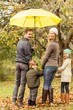 © WavebreakmediaMicro - Rear view of young smiling family under umbrella