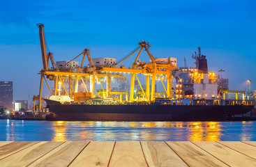 Gantry crane loading and unloading cargo container  from cargo ship at port to show global international logistics and transportation by cargo ship and cargo container, Logistic import export concept.