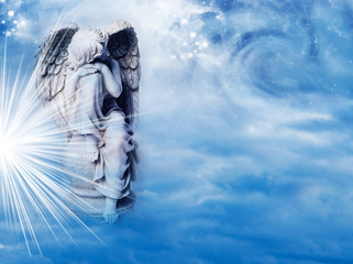 Wall Mural - an angel statue over mystical sky with divine light and stars