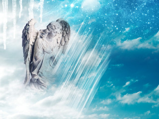 Wall Mural - an angel statue over mystical sky with divine light and stars