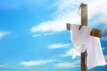 Wall Mural - Cross with crown of thorns and cloth on sky background