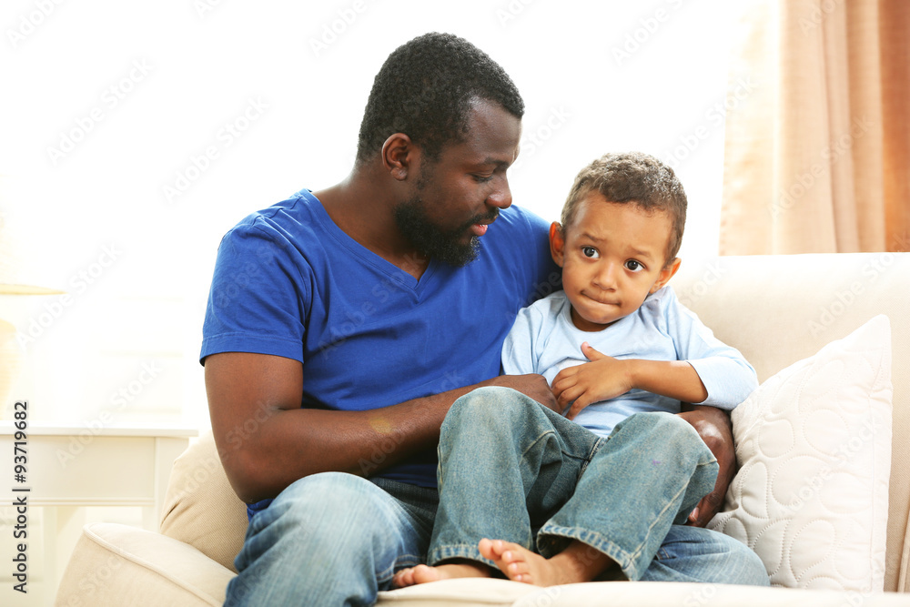 Father and son on sofa in the room