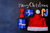 Fototapeta  - Merry Christmas written with chalk on a black background with wo