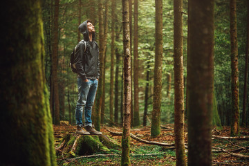 hooded man posing in the forest