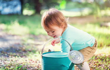 Happy toddler girl smiling and playing outside