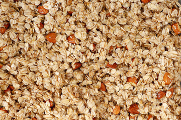 Background: granola with almonds and seeds before baking