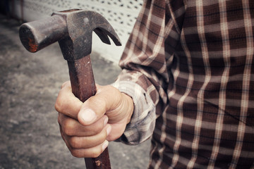 Man with hammer on hand