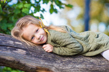 Wall Mural - Adorable little girl outdoors at beautiful autumn day