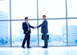 © lenets_tan - Full length image of two successful business men shaking hands