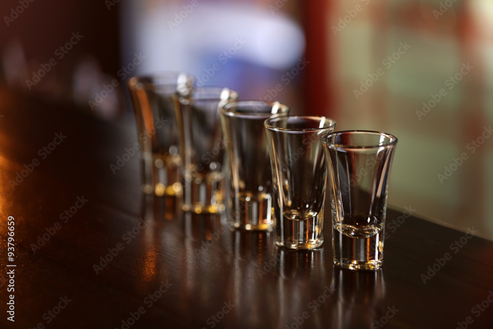 Empty shot glasses on bar counter