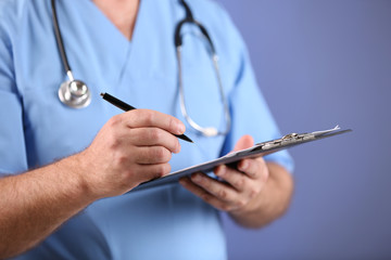 Doctor with clipboard on blue background