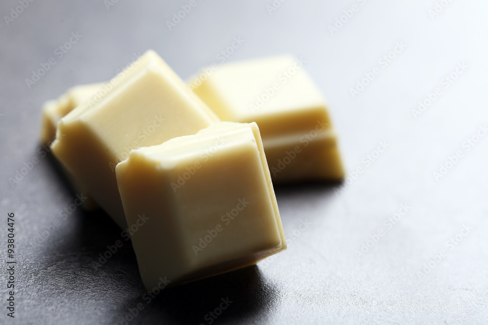 White chocolate pieces on gray background