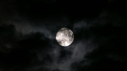 Wall Mural - full moon moving between clouds