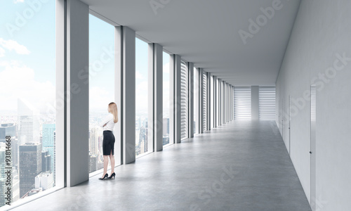 A Woman In Formal Clothes Is Looking Out The Window Empty