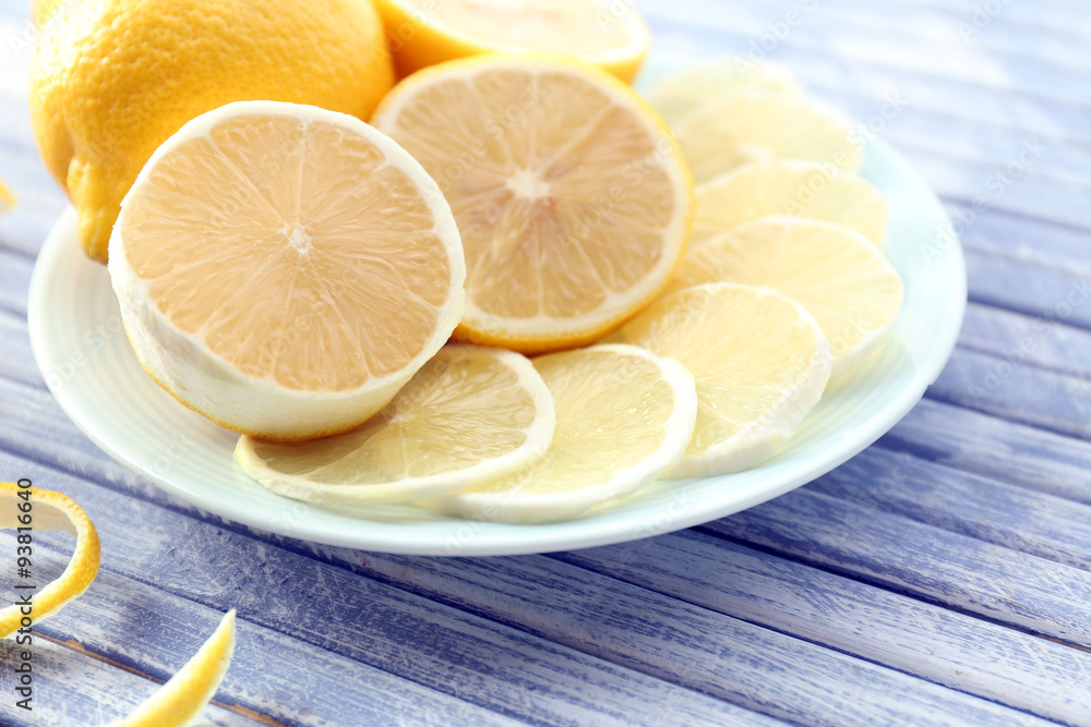 Ripe lemons on wooden table close up
