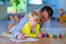 Father And Child Having Quality Time Together At Home. Happy Family Of Two, Loving Caring Dad With  Adorable Toddler Girl, Lying Cozy On Tiles Floor On Warm Lambskin Drawing With Colorful Pencils