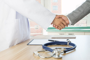 Wall Mural - Doctor and businessman shaking hands