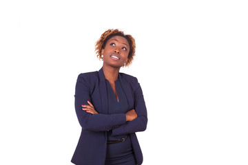 Wall Mural - African American woman with folded arms looking up , isolated on