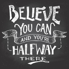 Believe you can and you're halfway there. Motivational hand-drawn lettering on blackboard background with chalk