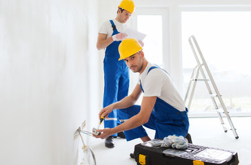 Canvas Print - builders with tablet pc and equipment indoors