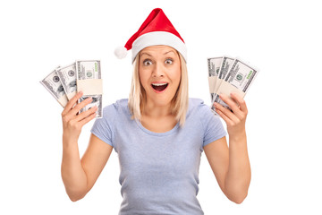 Wall Mural - Overjoyed woman with Santa hat holding money