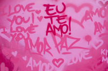 International Love And Peace Graffiti In English And Brazilian Portuguese Writing On Pink Wall In Rio De Janeiro, Brazil [English Translation: I Love You]