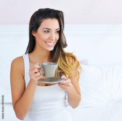 Beautiful Brunette Woman Drinking And Enjoying Morning Coffee In Bed 