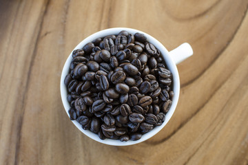 Wall Mural - Roasted coffee beans in white cup
