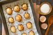 Homemade coconut macaroons (coconut meringue cookies) in baking pan, photographed overhead with natural light. Coconut macaroons are traditional Christmas cookies in Germany called Kokosmakronen.
